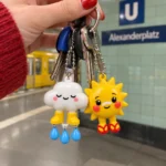 Cloud in Wellies & Sunburnt Sun Keychain Duo worn or in use