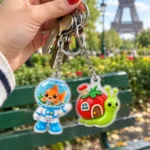 Goldfish Astronaut & Snail Mover Keychain Duo worn or in use